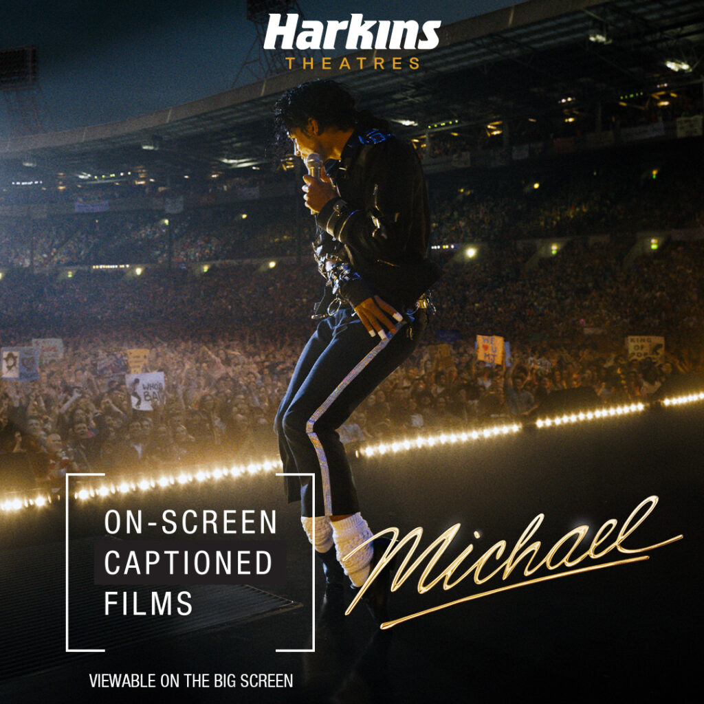 Michael Jackson doing his famous dance in the front of the audience