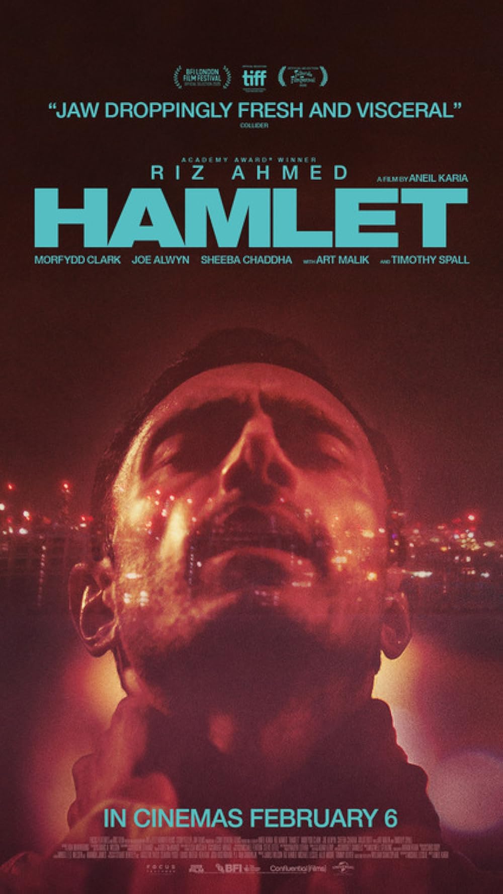 A man with his eyes closed, his face up towards the nighttime.