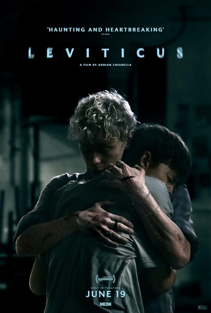 Two people are hugging each other. One person has cuts all over their hands and arms.